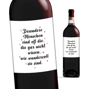 Detail of personalized German wine bottle labels with red heart motifs for celebrations