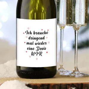 Close-up of German wine bottle label Ich brauche dringend eine Dosis WIR on a wooden table