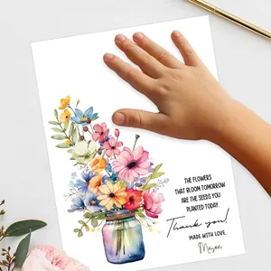 Nahaufnahme des personalisierten Abschiedsgeschenks für Lehrer mit Handabdruck und Blumen