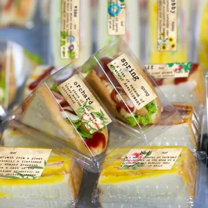 Detail of vintage floral labels on transparent sandwich boxes for creative food packaging