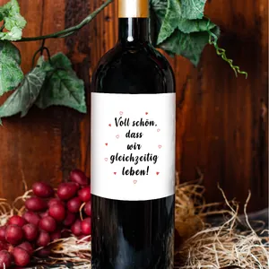 Detail of German quote wine bottle label with red hearts on dark glass bottle