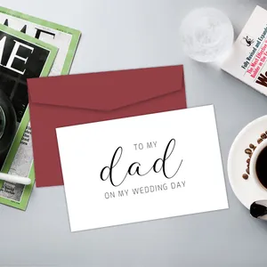Detail view of a wedding card for dad with a burgundy envelope and elegant script