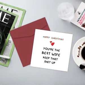 Funny Christmas card for wife with red envelope on a cozy desk with a coffee cup