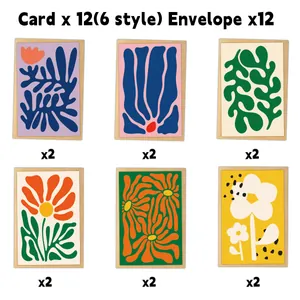 Vista piana di 12 biglietti d'auguri stile Matisse e buste kraft su sfondo bianco