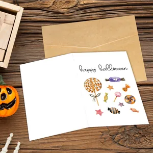 Happy Halloween greeting card with black cat design and envelope on a rustic wooden background