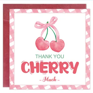 Détail de carte de remerciement avec cerises rouges, nœud rose et enveloppe rouge