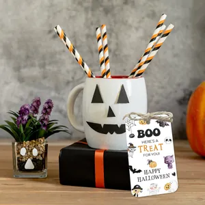 Detail view of Halloween gift tag with Boo message on a gift box and white ceramic mug