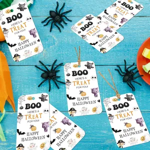 Halloween gift tags with cartoon bats and pumpkins on a blue wooden background