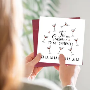 Funny 'Tis the Season to Get Shitfaced' Christmas card with a red envelope in hand