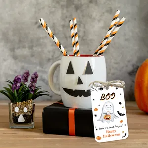 Detail of Halloween ghost gift tags with twine on festive orange and black background