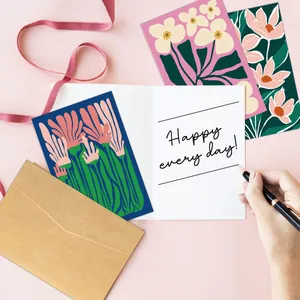 Detailed close-up of floral thank you cards with kraft envelopes and handwritten note