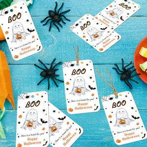 Halloween gift tags with ghosts and pumpkins on a blue wooden background for candy bags