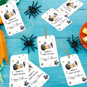 Detail of Halloween paper gift tags with festive ghosts, bats, and hanging twine strings