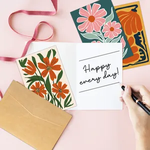 Detailed close-up of floral thank you cards with brown envelope and pink ribbon