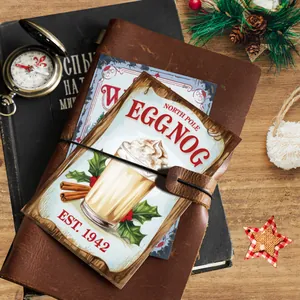 Detail of vintage Christmas postcard with egg nog illustration on a rustic wooden table