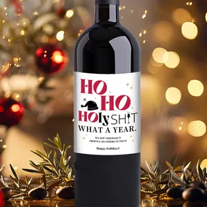 Close-up of funny Christmas wine label on bottle with warm festive bokeh background