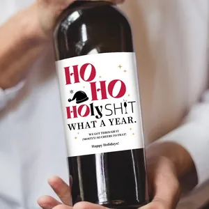 Close-up of waterproof Christmas wine bottle sticker with holiday text and stars