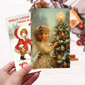 Close-up of vintage Christmas postcards with retro holiday illustrations on a wooden table