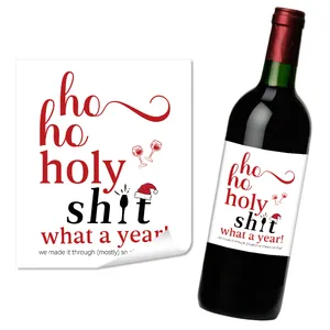 Macro view of Christmas wine bottle labels with humorous 'ho ho holy shit' typography