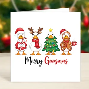 Close-up of Merry Goosmas card featuring funny cartoon ducks on a warm wooden background