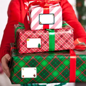 Close-up of festive Christmas gift tag stickers on wrapped holiday present boxes