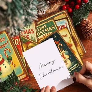 Set of 12 vintage Christmas postcards with snowman and pine tree on a wooden table