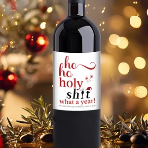 Close-up of waterproof Christmas wine bottle label with funny holiday quote decoration