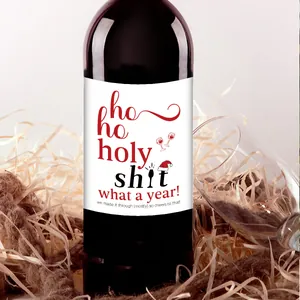 Detailed view of festive Christmas wine bottle label with holy shit text on bottle