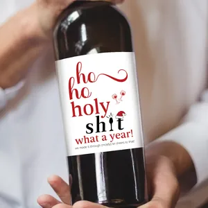 Macro shot of waterproof Christmas wine bottle stickers with humorous holiday text