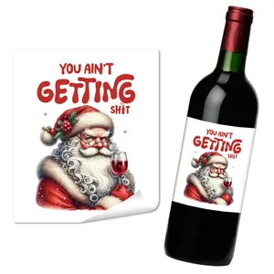 Detail view of funny Santa Claus wine bottle sticker with humorous bold red typography