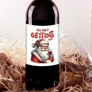 Close-up of Santa illustration waterproof Christmas wine bottle label on dark glass