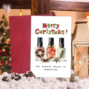 Detailed view of a Christmas card with nail polish artwork and a red envelope