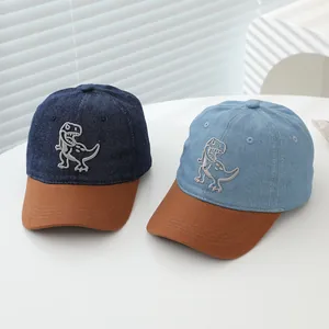 Kids denim baseball caps with 3D dinosaur embroidery in navy and light blue