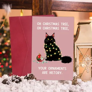 Macro detail of humorous Christmas card with black cat illustration and red envelope