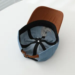 Detailed interior of denim kids baseball cap with sweatband and cartoon embroidery