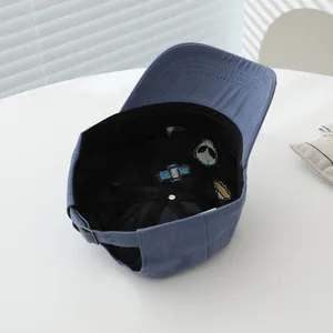 Detail of blue cotton baseball cap with alien embroidery and adjustable metal buckle