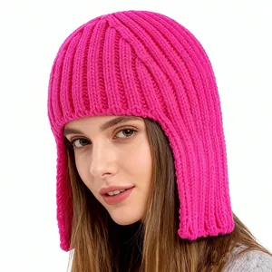 Close-up of bright pink knitted ear-protection beanie with vertical ribbed texture