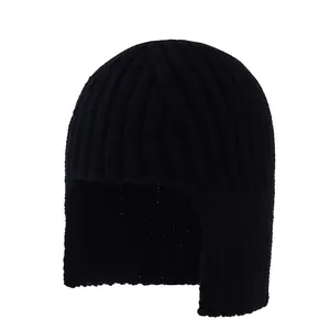 Detailed knit texture and earflap design of a warm black winter beanie with ribbed pattern
