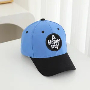 Detail of blue and black color-block baseball cap with A Happy DAY embroidery