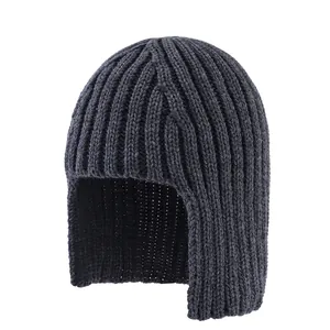 Close-up of charcoal grey knitted beanie featuring thick ribbed texture and ear protection