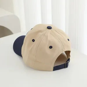 Rear view of contrast baseball cap with adjustable metal buckle and navy blue fabric strap