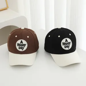 Minimalist kids baseball cap featuring A Happy Day embroidery in brown and black