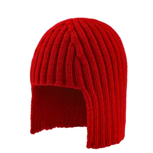 Detail of red ribbed knit trapper hat showing thick wool texture and ear flaps