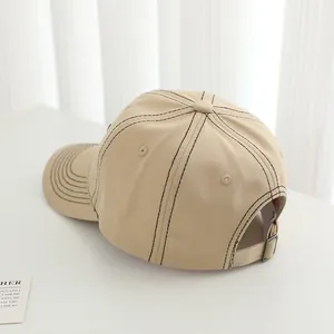 Close-up of khaki cotton baseball cap with black contrast stitching and metal buckle