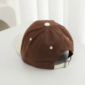 Detail view of cotton baseball cap showing contrast colors and adjustable metal buckle