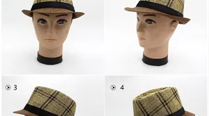 Dettaglio di un cappello fedora in paglia kaki con motivo a quadri e nastro