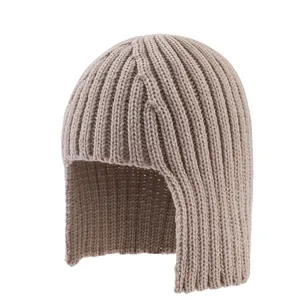 Close-up of beige ribbed knit texture and ear protection design on a warm winter beanie