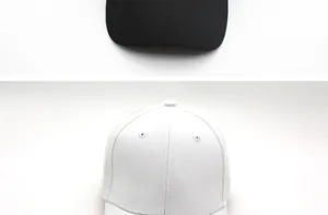 Close-up of high-quality cotton fabric and reinforced stitching on black and white baseball caps