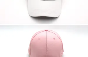 Detailed stitching and breathable eyelets on white and pink cotton baseball caps