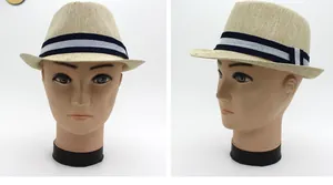 Detail of breathable woven texture and striped ribbon on a beige straw fedora hat